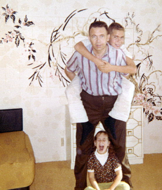 This picture shows my brother and father "horsing around." I wonder what I was screaming about!