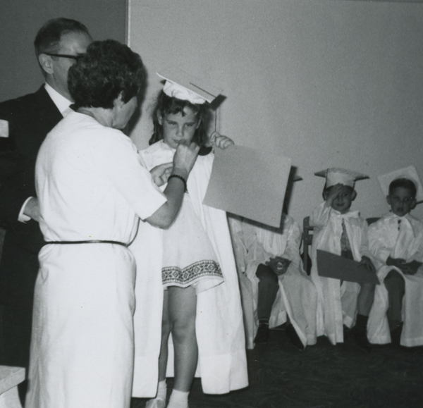 In this picture my mom is with me as I graduate preschool.
