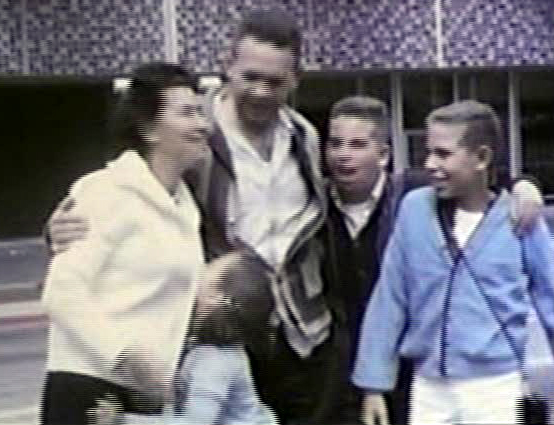 This picture is from an old home movie. I love the way I'm kissing my mother.