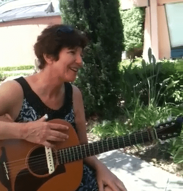 In this picture, I'm playing my guitar for my mother in the garden of her nursing home.
