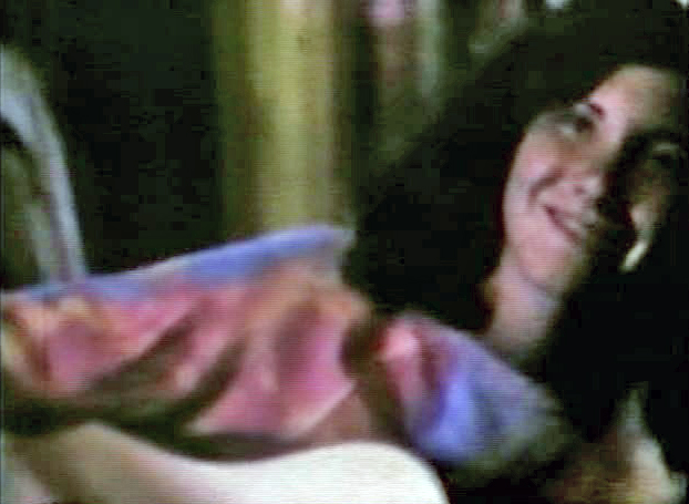 This is a snapshot from an old home movie of me playing the guitar when I was 17.