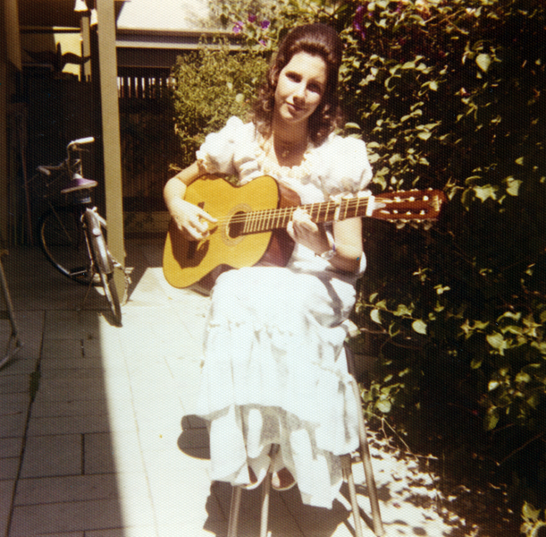 In this picture, I am playing guitar on the patio where I now live.