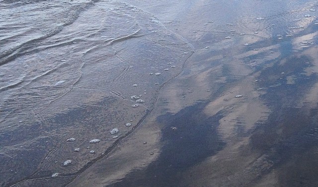 This close up really shows the amazing reflections of clouds on the wet sand.