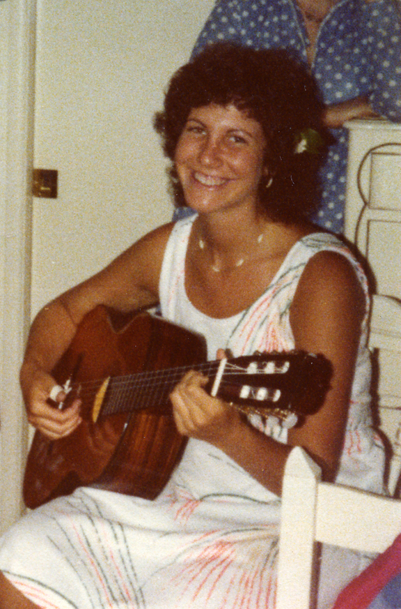 In this photo, I am playing my classical guitar at the age of twenty. 