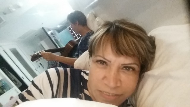 tuning-my-guitar-on-the-bed