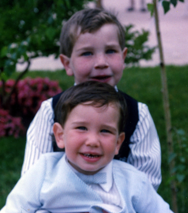 In this picture, Jason is holding his brother. Jason died five months after this picture was taken.